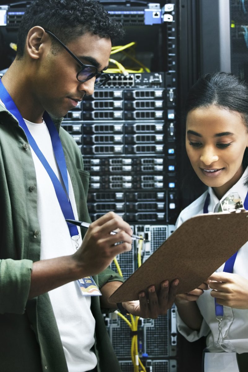 Computer center, team and data engineer with checklist, collaboration and people as programmer. Technician, clipboard and hardware security in server room for system update, analytics or maintenance.